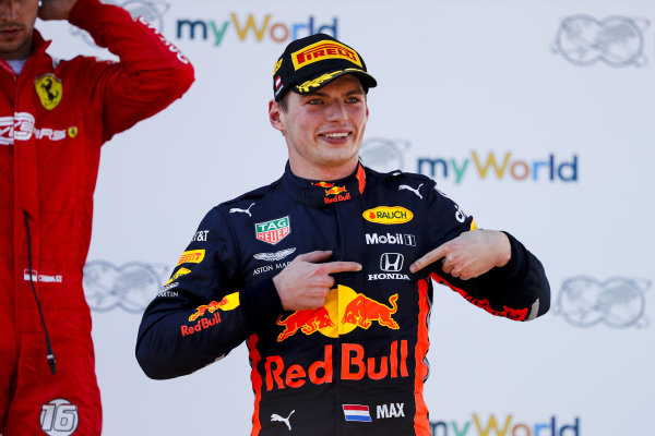 Race winner Max Verstappen, Red Bull Racing celebrates on the podium by pointing to the Honda badge on his overalls Race winner Max Verstappen, Red Bull Racing celebrates on the podium by pointing to the Honda badge on his overalls
