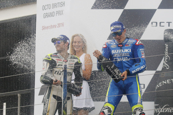 2016 MotoGP Championship. 
British Grand Prix. 
Silverstone, England. 2nd - 4th September 2016. 
Maverick Vinales, Suzuki, celebrates his first MotoGP win on the podium alongside Cal Crutchlow, LCR Honda. 
Ref: _W7_9526a. World copyright: Kevin Wood/LAT Photographic