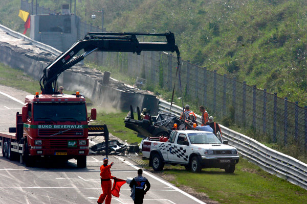 2004 DTM Championship
Zandvoort, Netherlands. 4th - 5th September.
The remains of Peter Dumbreck's OPC Phoenix Opel Vectra GTS are lifted away from the side of the track.
World Copyright: Andre Irlmeier/LAT Photographic
ref: Digital Image Only