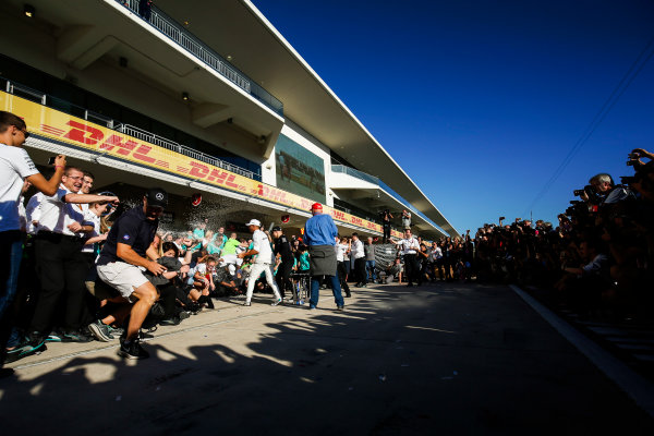 Circuit of the Americas, Austin, Texas, United States of America.
Sunday 22 October 2017.
Niki Lauda, Non-Executive Chairman, Mercedes AMG, Lewis Hamilton, Mercedes AMG, and Valtteri Bottas, Mercedes AMG, spray the champagne with the rest of the team as they celebrate Constructors’ Championship victory.
World Copyright: Zak Mauger/LAT Images 
ref: Digital Image _X0W7332